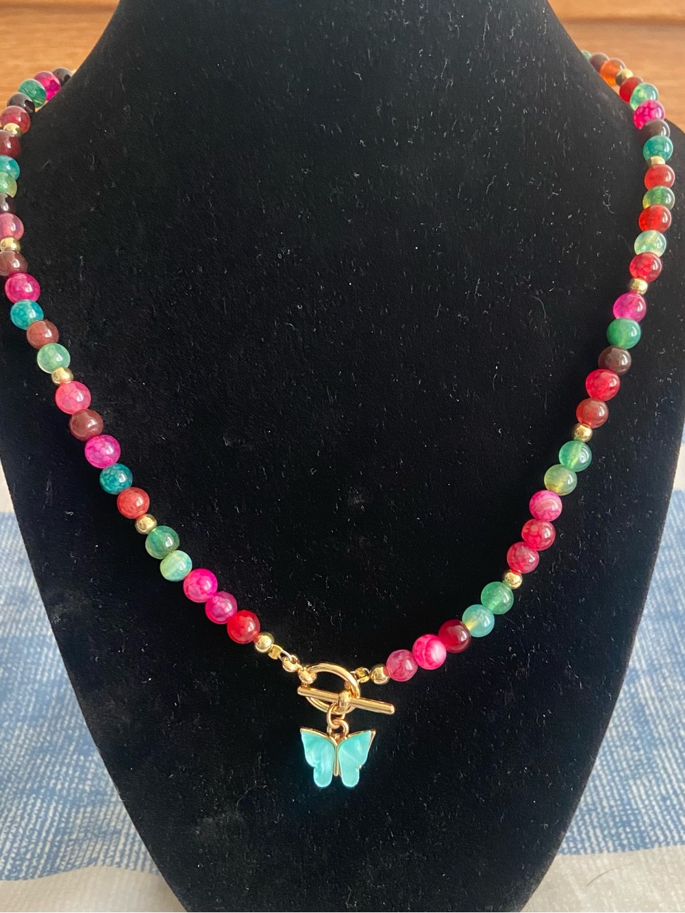 Multicolor Beaded Necklace with Gold Toggle and Turquoise Butterfly Charm